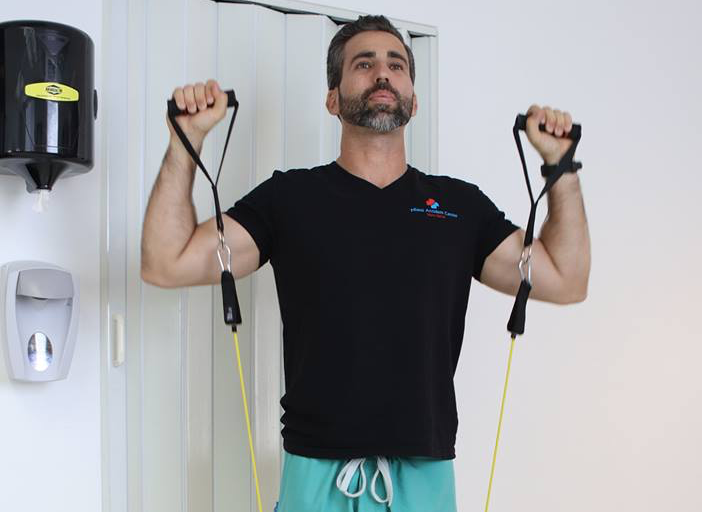 Clinic worker using resistance bands